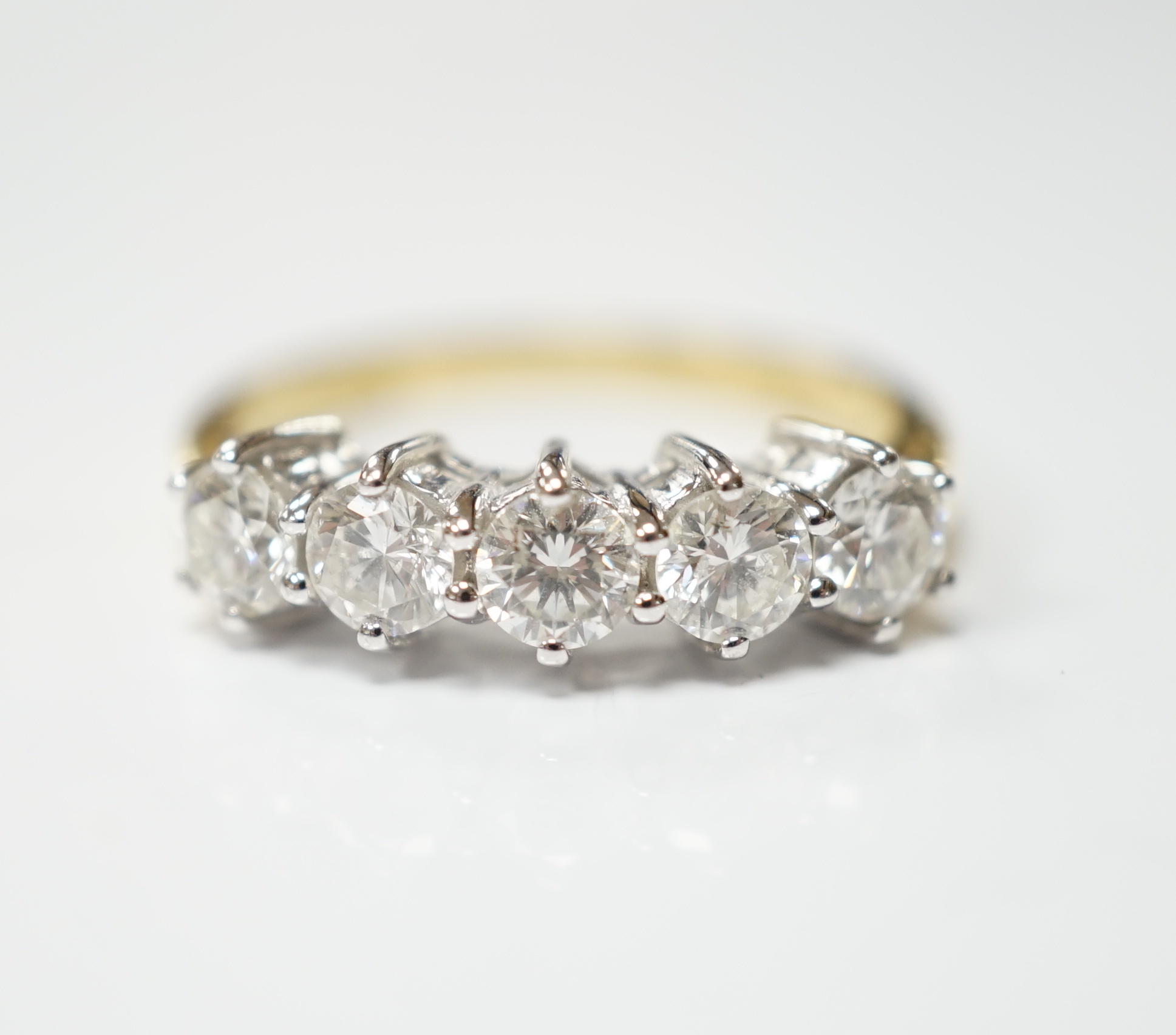 A modern 18ct gold and five stone diamond set half hoop ring, size N, gross weight 4 grams.